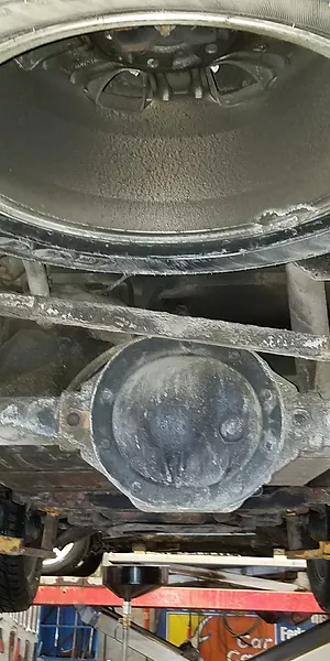 The picture reveals the significant harm caused to the undercarriage of the vehicle due to harsh weather conditions and the absence of rust proofing service.