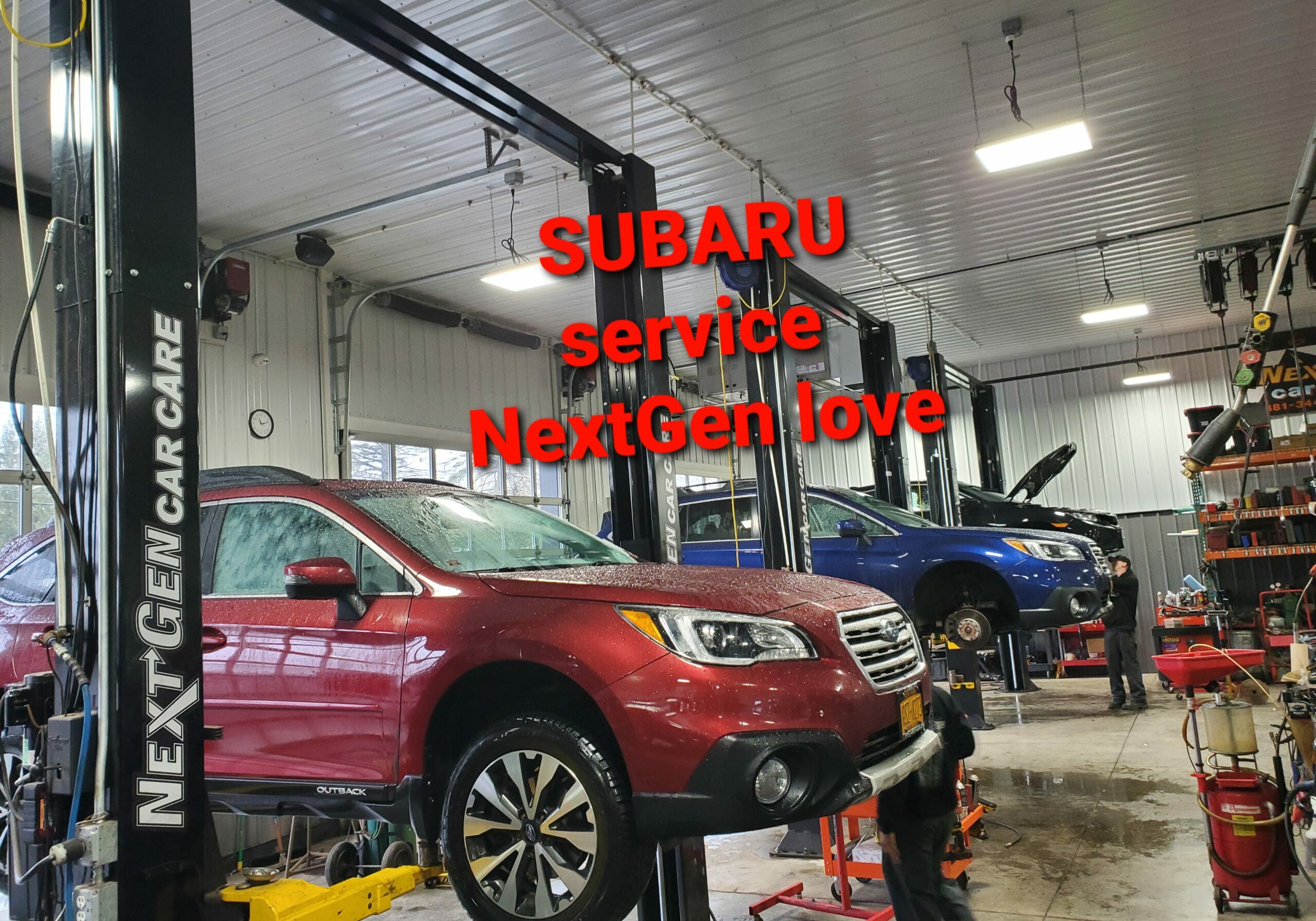 Red Subaru on a lift